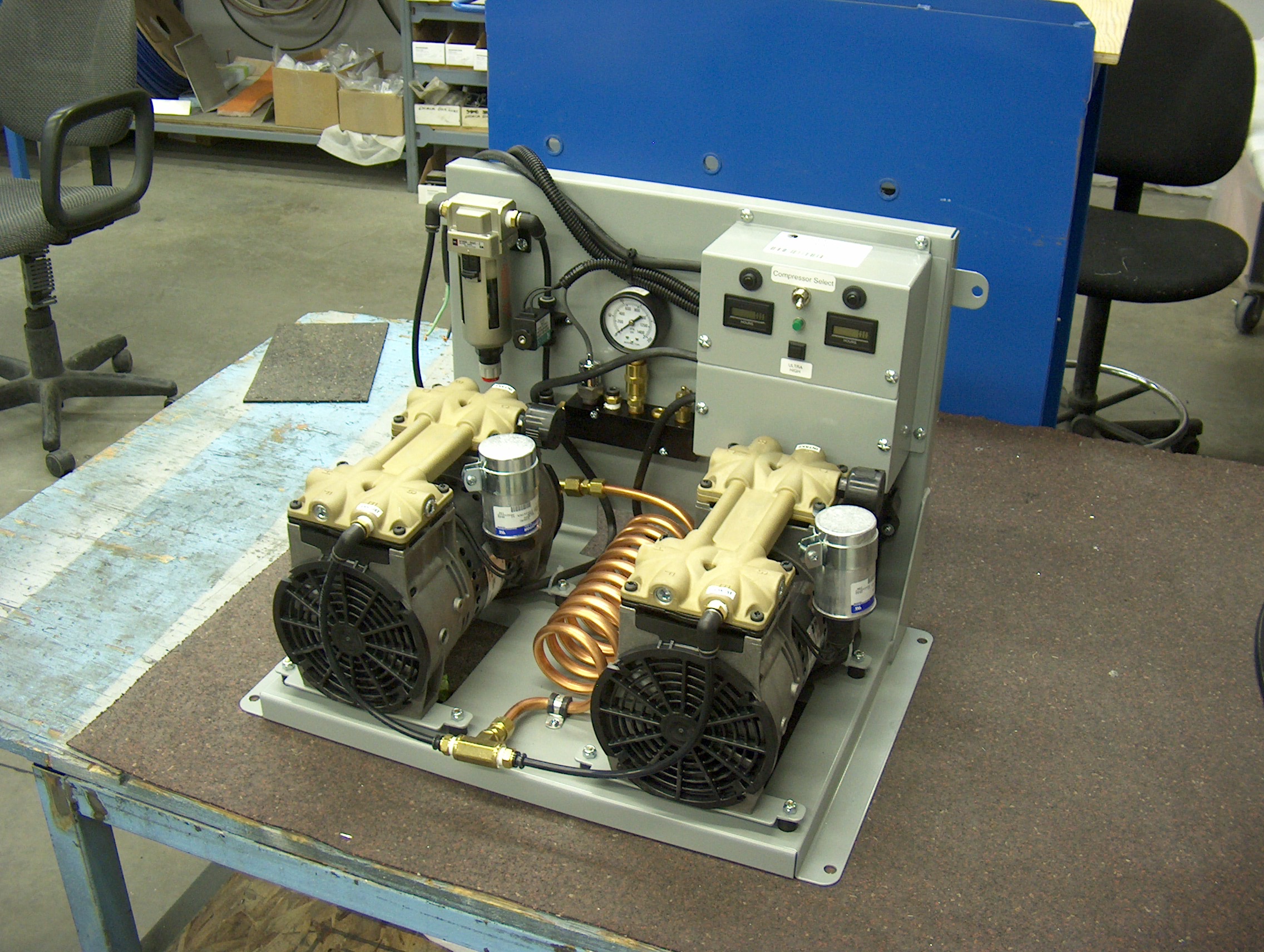 Overhead view of Valid Manufacturing auxiliary air compressor on a table.