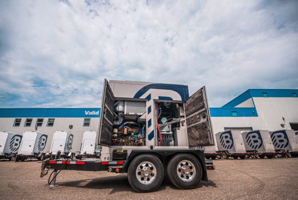 movie studio portable power supply on a trailer with all of it's doors opened.