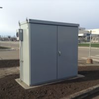 Free standing Electronic Vehicle Charger Distribution kiosk in a parking lot.