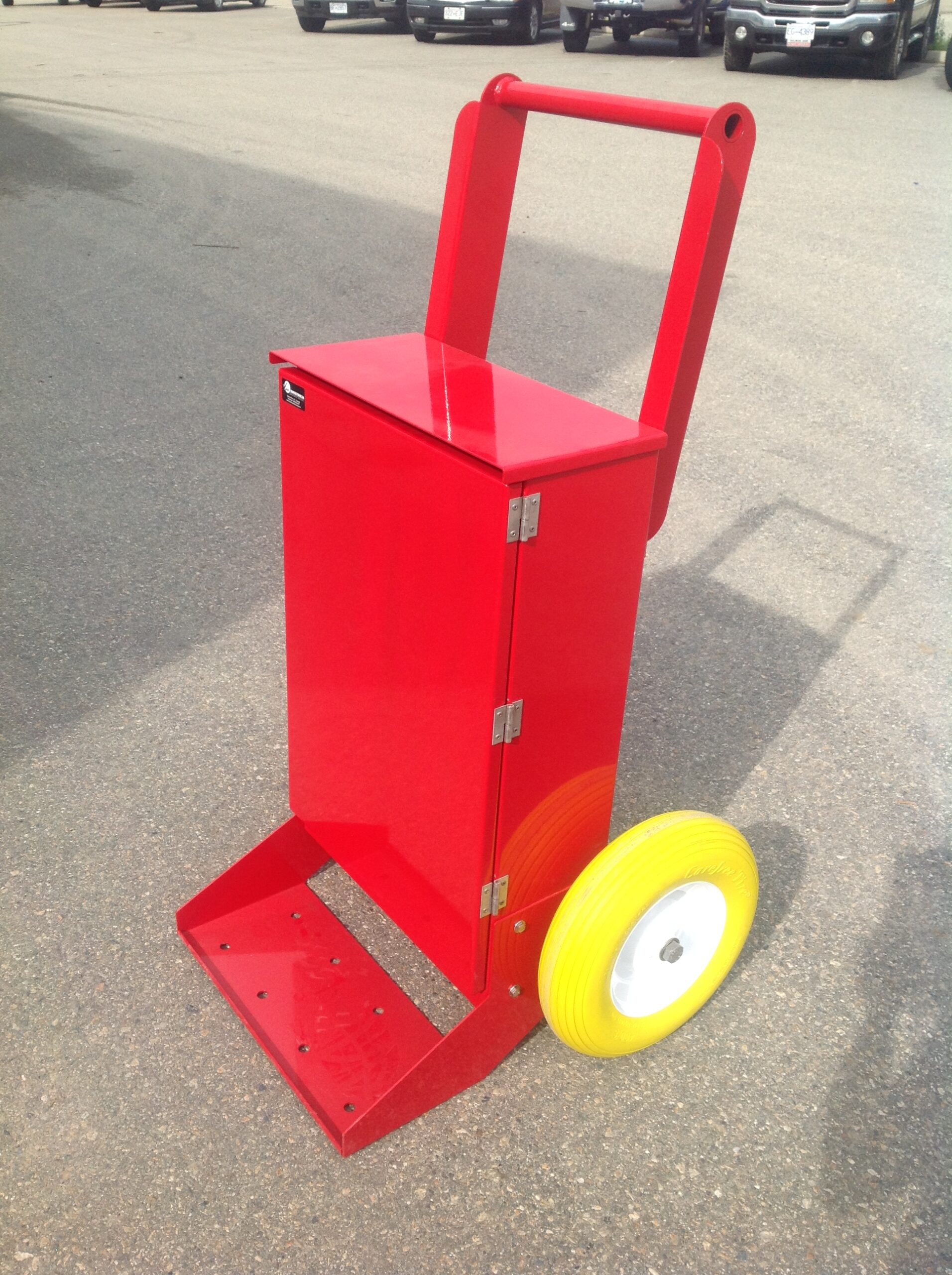 Side view of a red temporary power distribution cart in a parking lot.