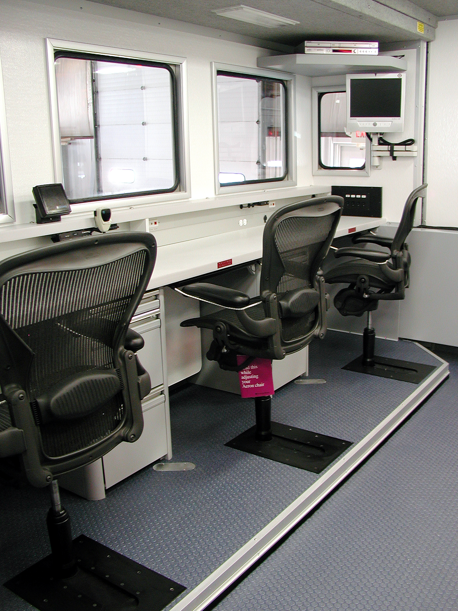 Workstation with three office chairs in a row that are equipped with Valid's adjustable chair slides.